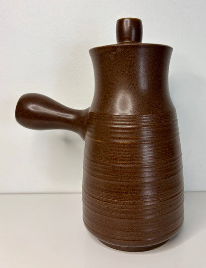 brown denby coffee pot with ribbed design and single handle