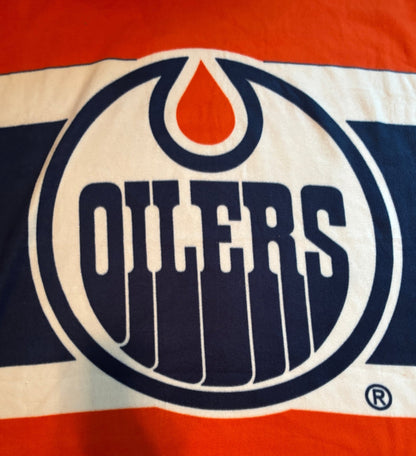 Edmonton Oilers logo on a red and blue background