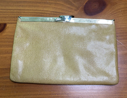 Gold clutch bag on a wooden surface