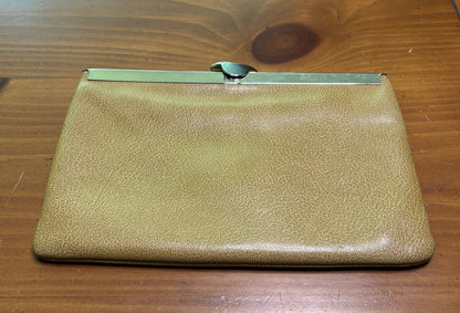 Gold clutch purse on a wooden surface