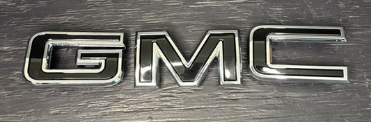 Chrome GMC logo on a textured background