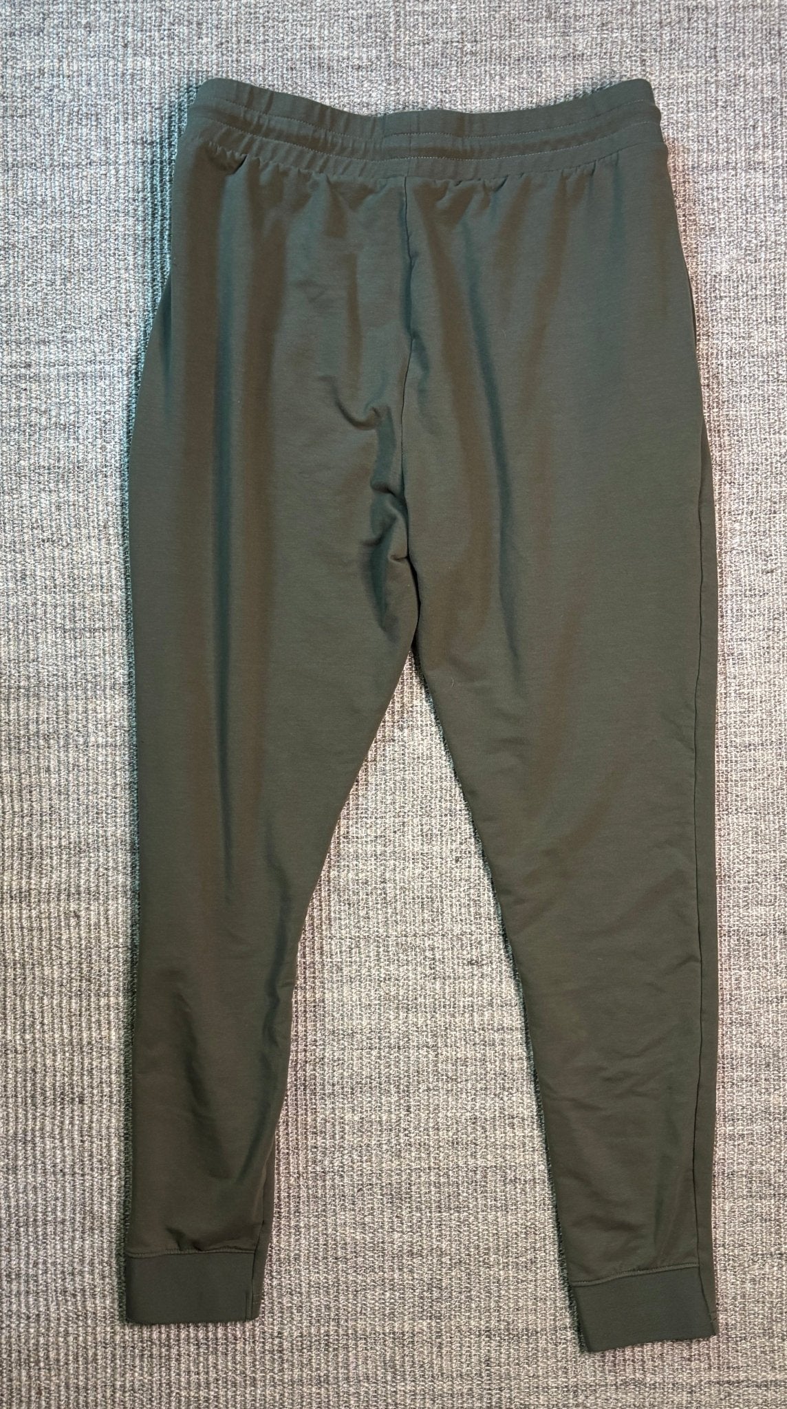 Green pants on a textured gray surface