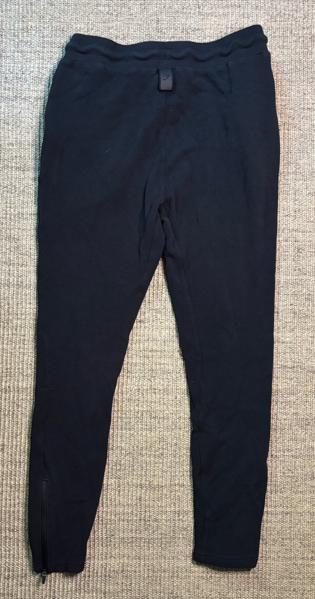 Navy blue pants on a textured gray surface