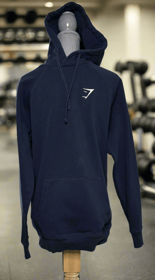 Navy blue hoodie with a white logo on a mannequin in a gym setting