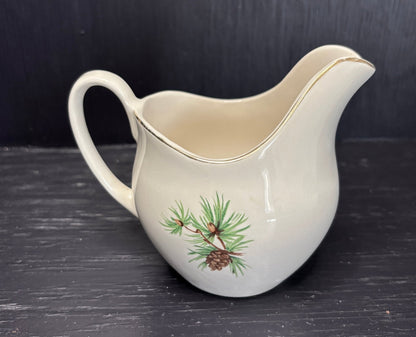 creamer with a Pine Cone design