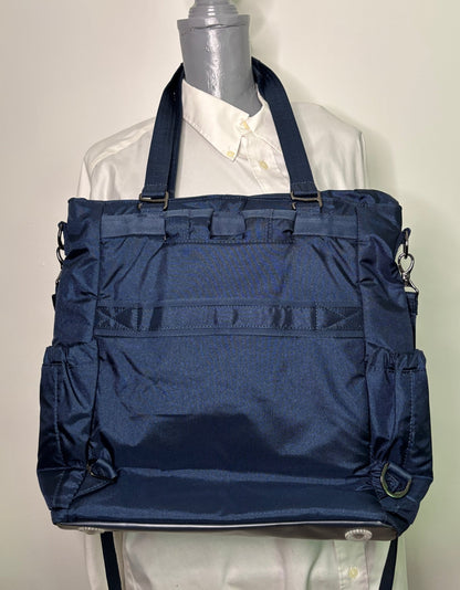Navy blue backpack on a mannequin with a white shirt underneath