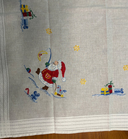 Embroidered fabric with Santa Claus design on a gray background