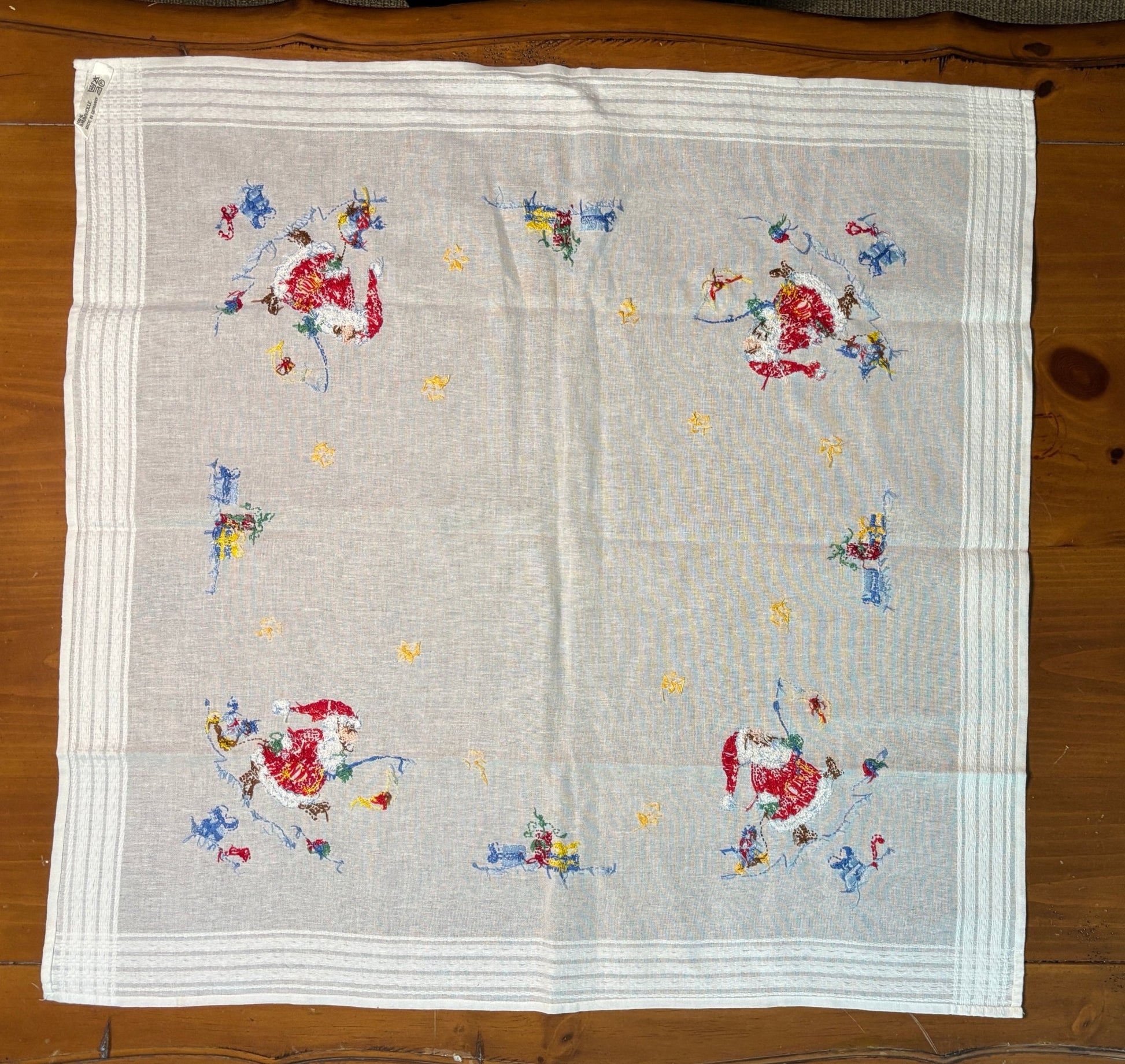 Embroidered fabric with floral patterns on a wooden surface
