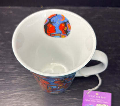 White mug with colorful design on a dark surface