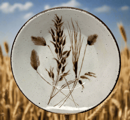 Ceramic plate with botanical design in a field of wheat
