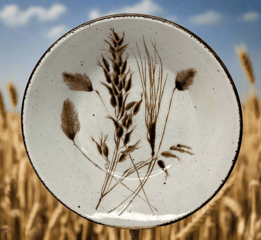 Ceramic plate with botanical design in a field of wheat