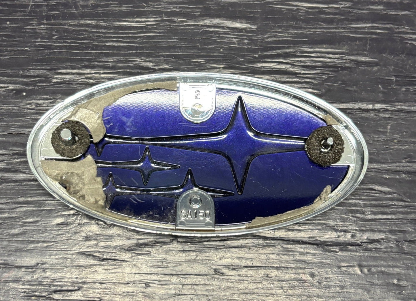 Subaru emblem on a wooden surface