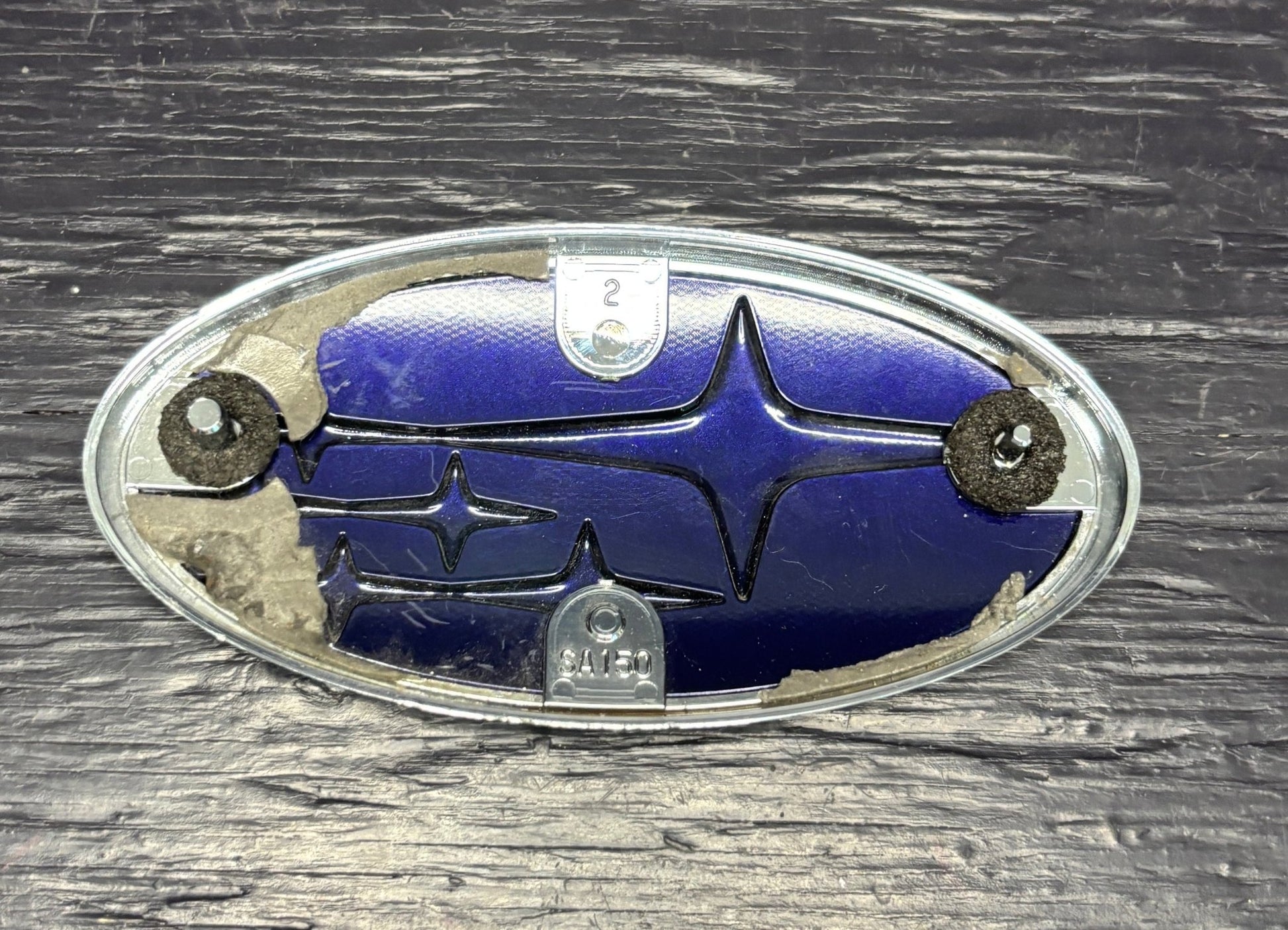 Subaru emblem on a wooden surface
