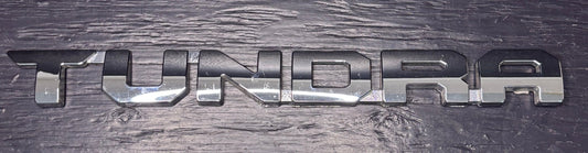 Metallic 'TUNDRA' logo on a textured surface